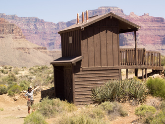 Meg shows off the outhouse on the Tonto Plateau.